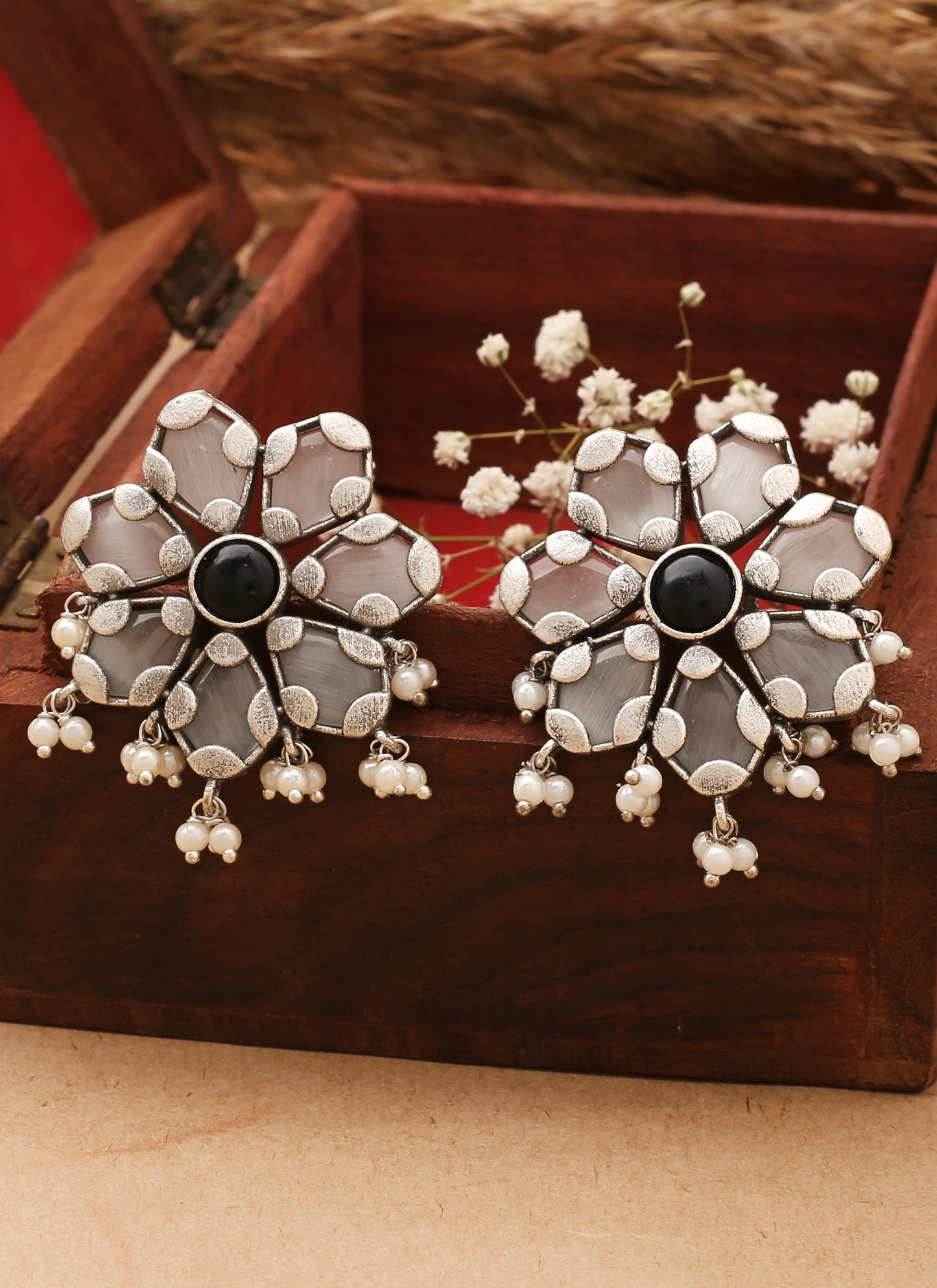 White Floral Shaped Earrings With Black Stone