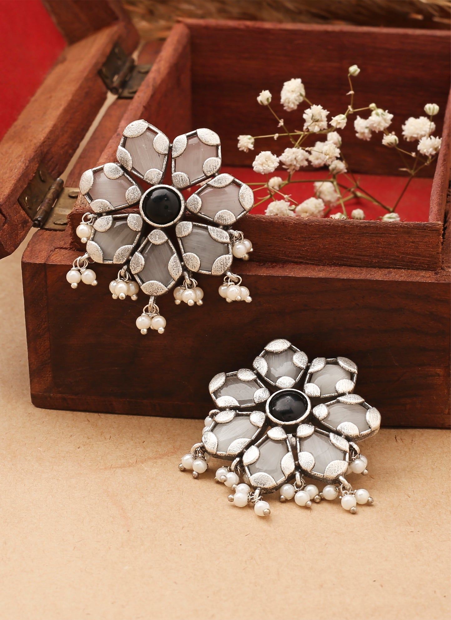 White Floral Shaped Earrings With Black Stone