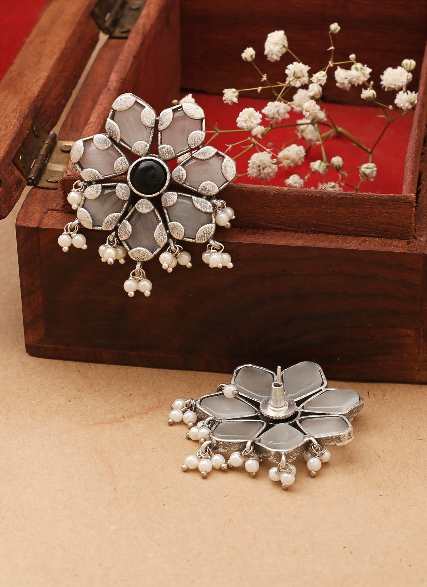 White Floral Shaped Earrings With Black Stone