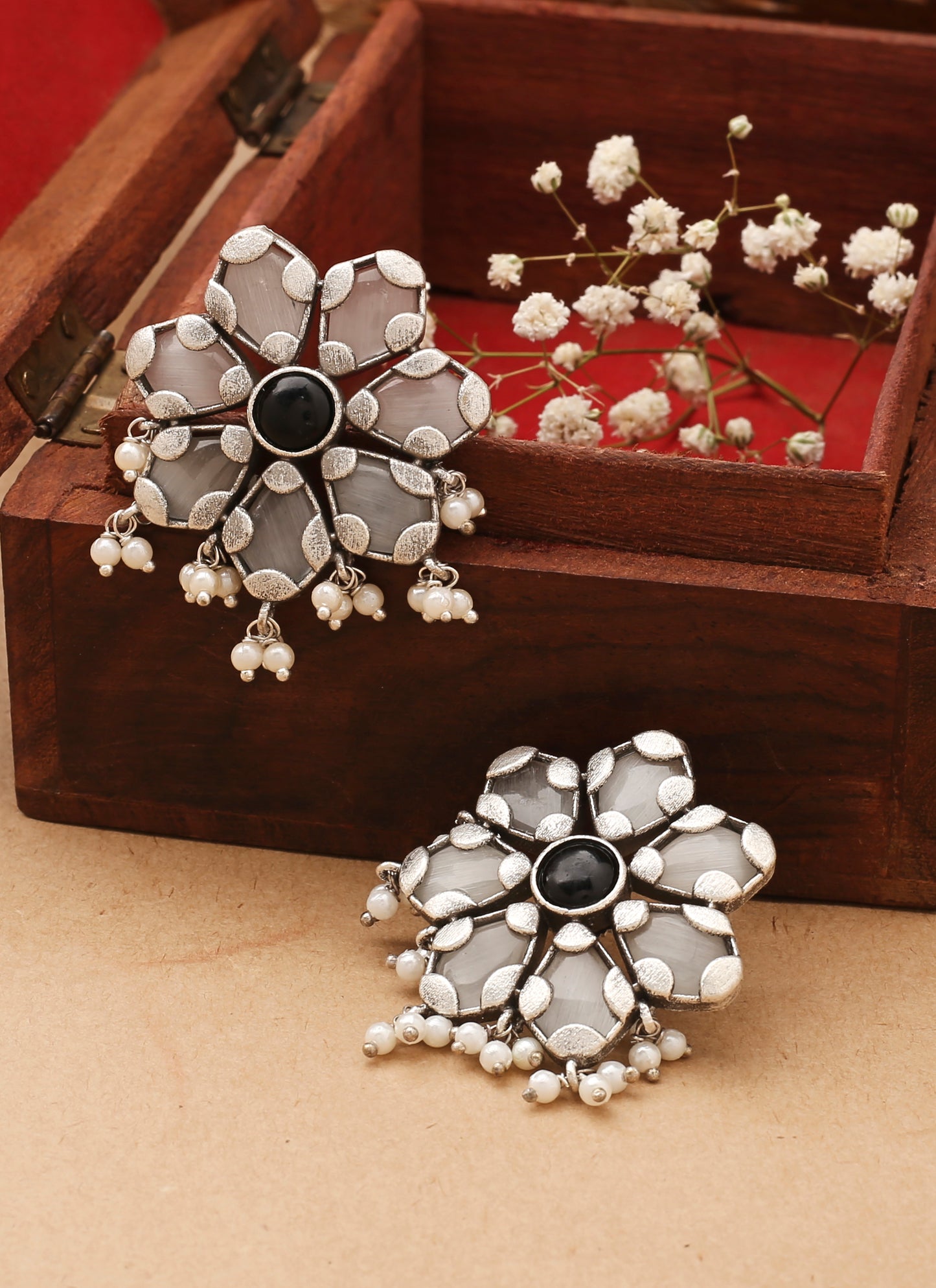 White Floral Shaped Earrings With Black Stone