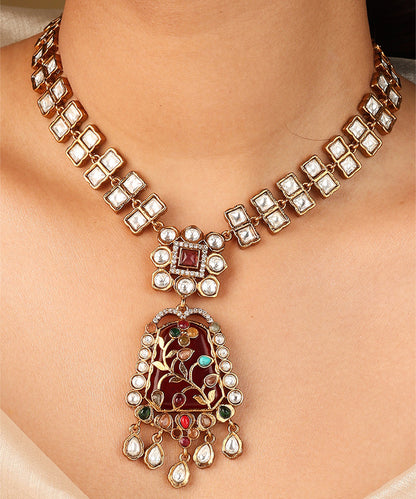 Gold Carved Necklace Set with Red Stones and White Kundan