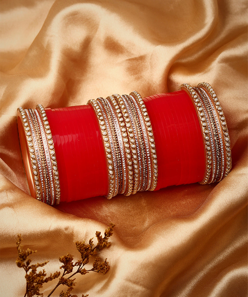 Set Of twenty-four Gold Plated Red AD Stone Studded Chuda Set