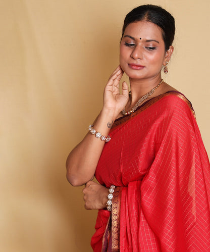 Stunning Red Saree with Ornate Zari Border and Festive Blouse