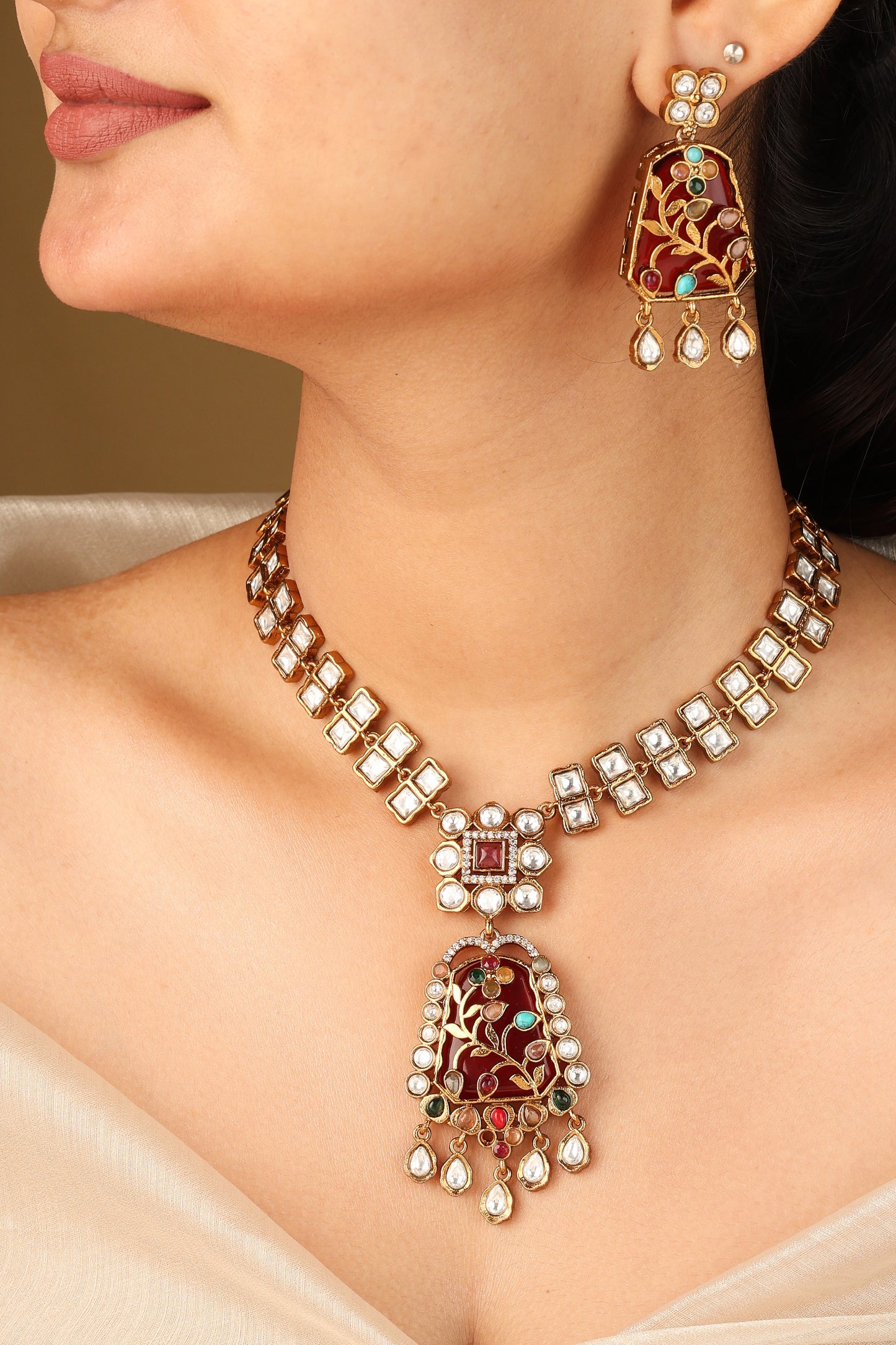 Gold Carved Necklace Set with Red Stones and White Kundan