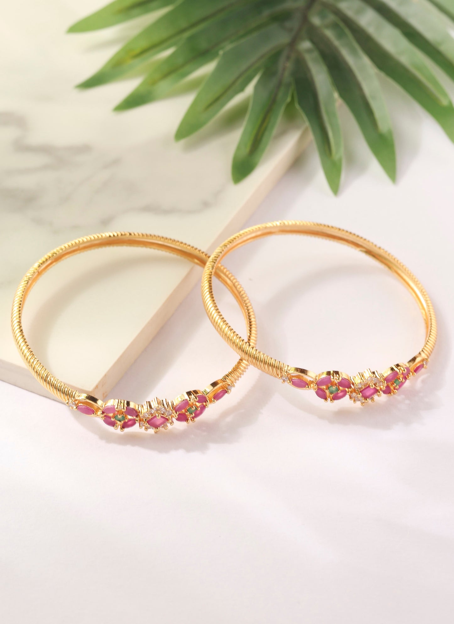 Set of two Gold Bangles with Pink Stone Center Detailing