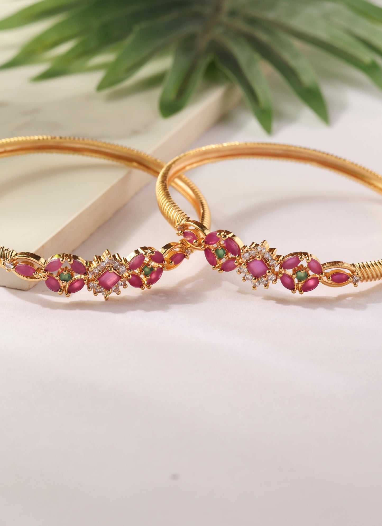 Set of two Gold Bangles with Pink Stone Center Detailing