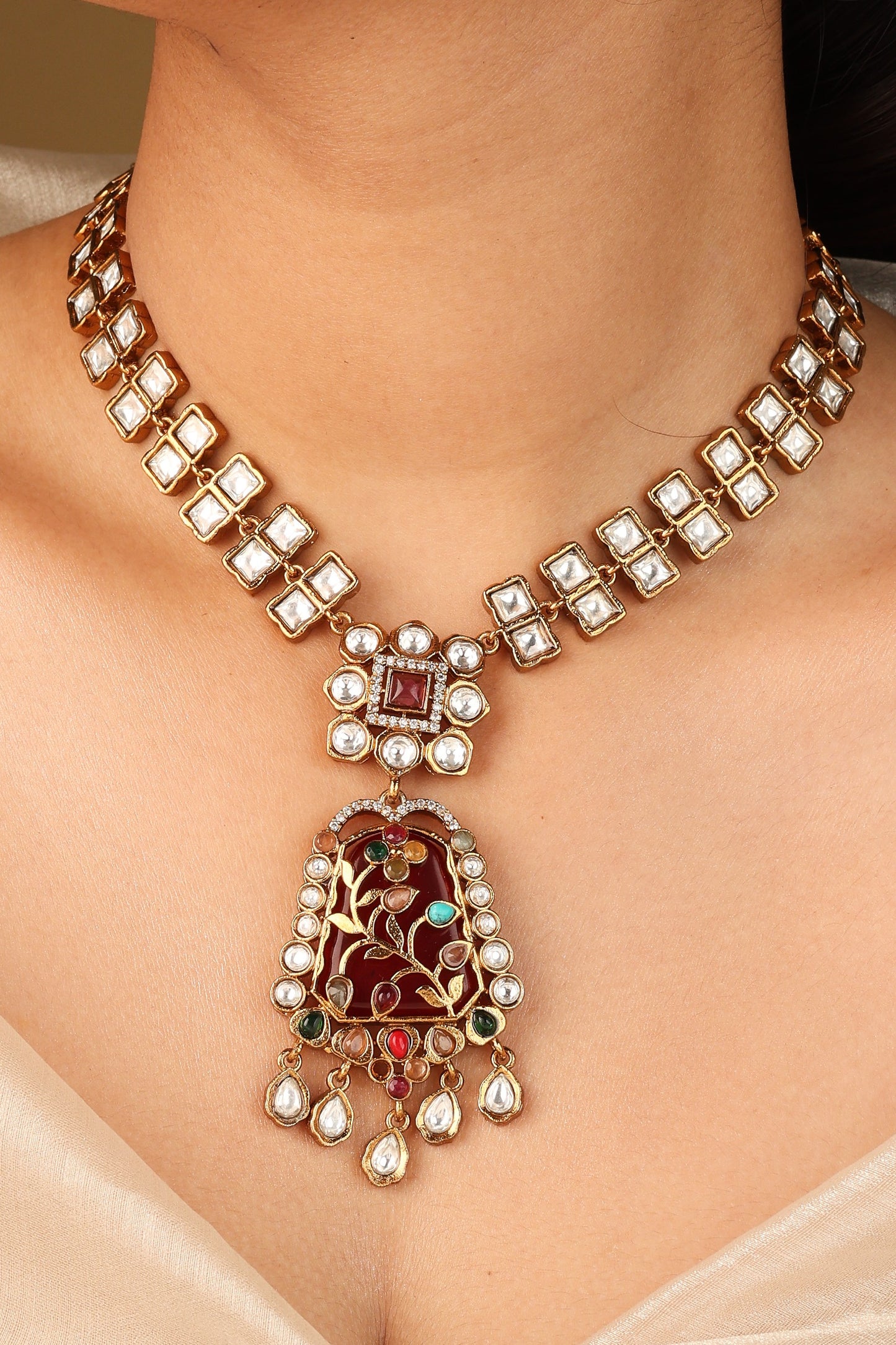 Gold Carved Necklace Set with Red Stones and White Kundan