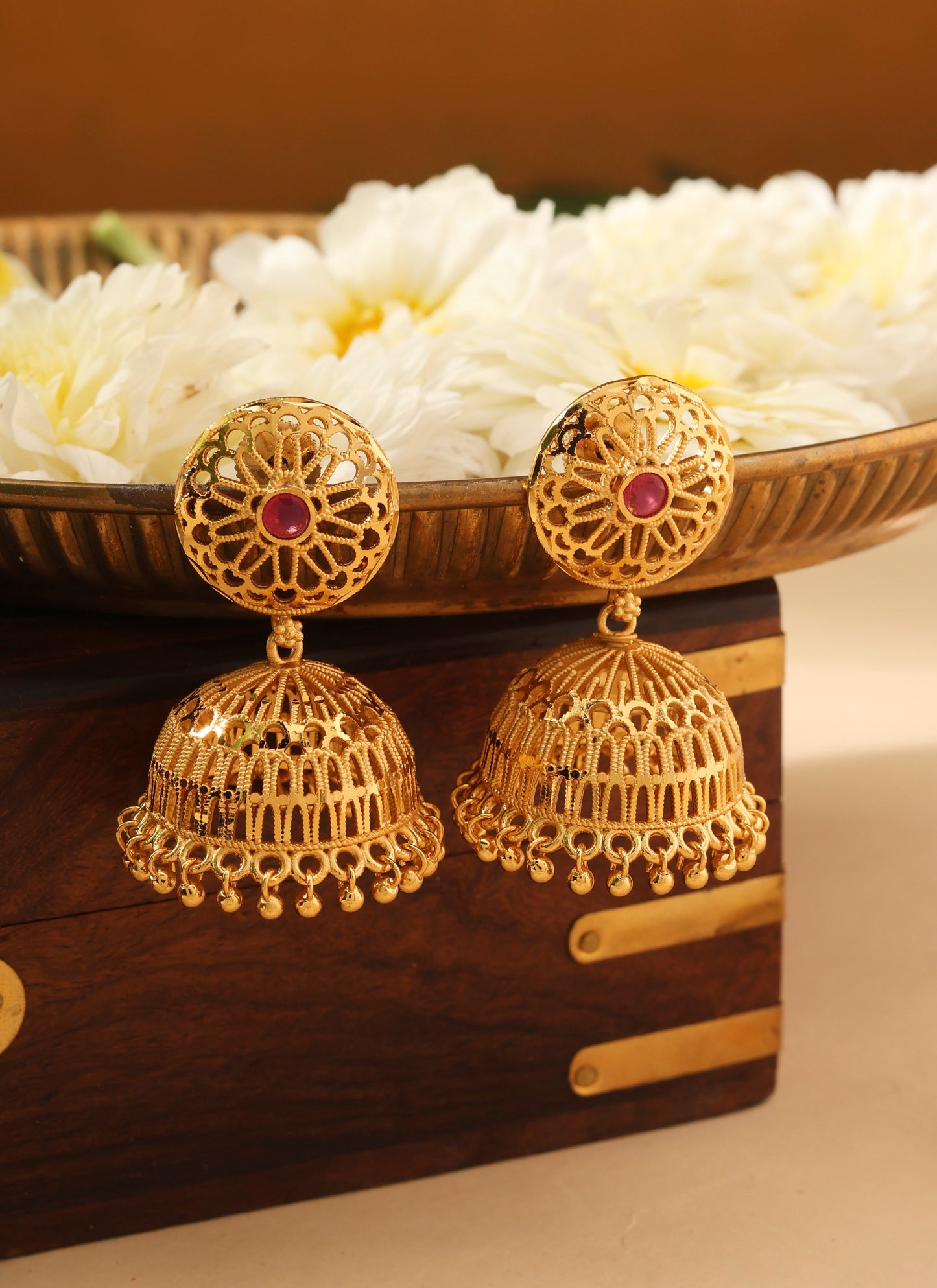 Gold Jhumkas with Pink Stone Accent