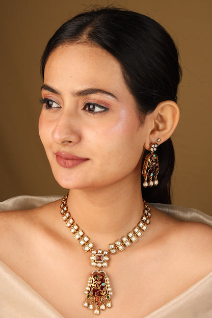 Gold Carved Necklace Set with Red Stones and White Kundan